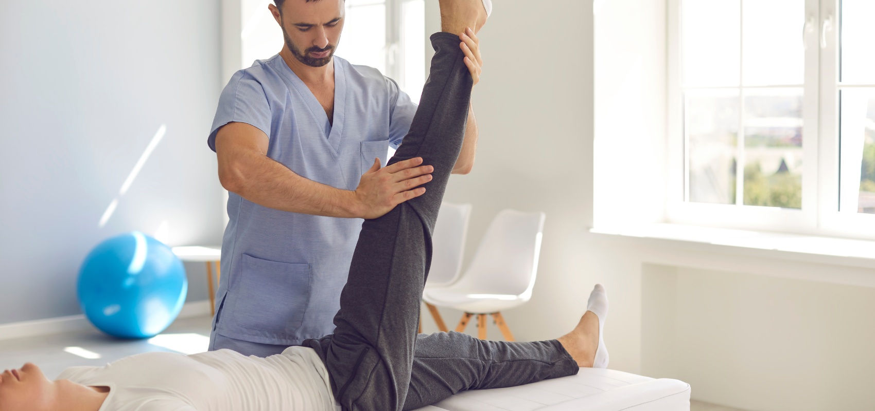 a physical therapist in light blue scrubs