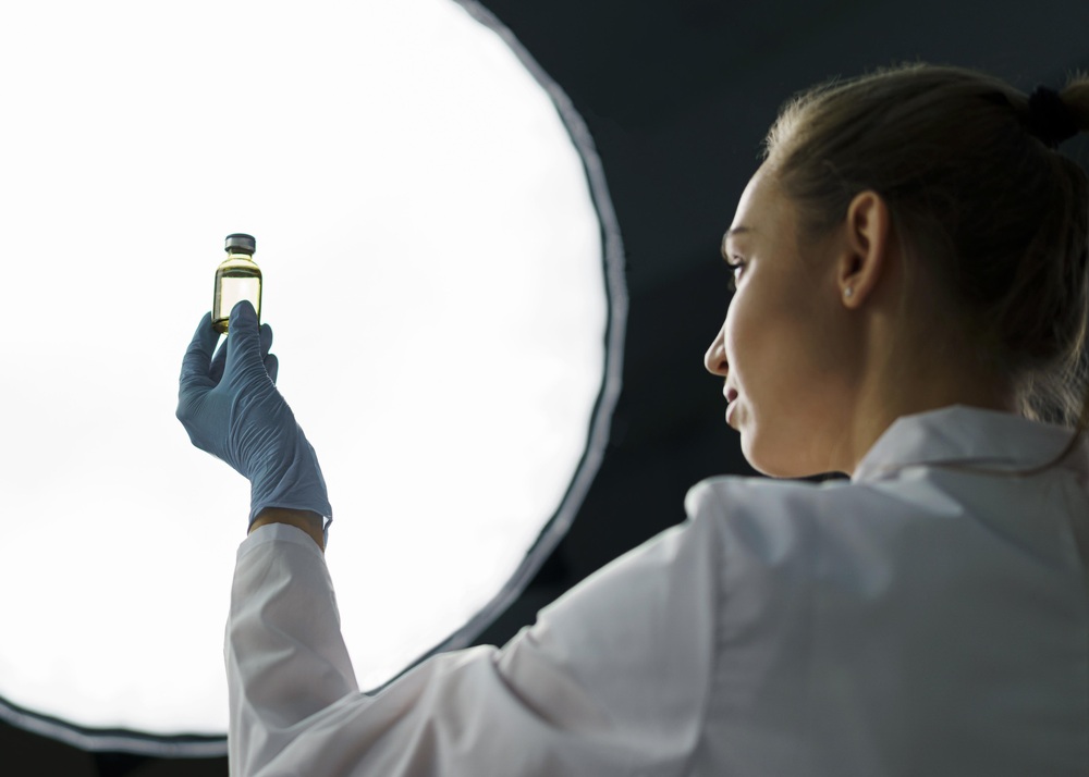 female-researcher-laboratory-holding-vaccine-bottle-light-1.jpg