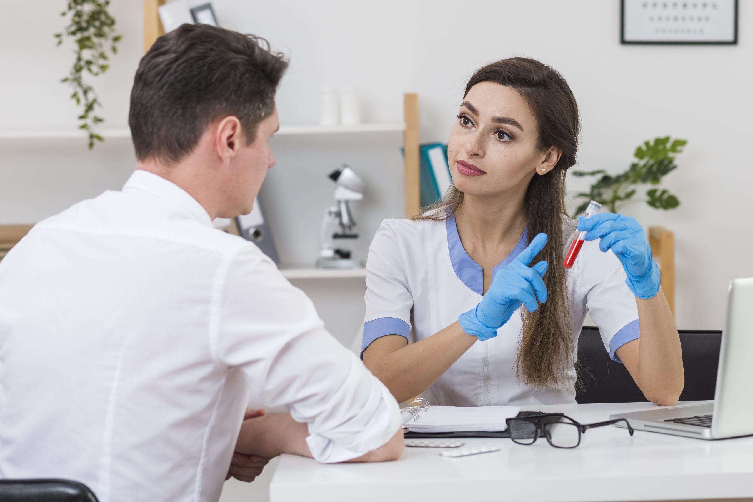 beautiful-doctor-showing-blood-sample-patient-scaled.jpg