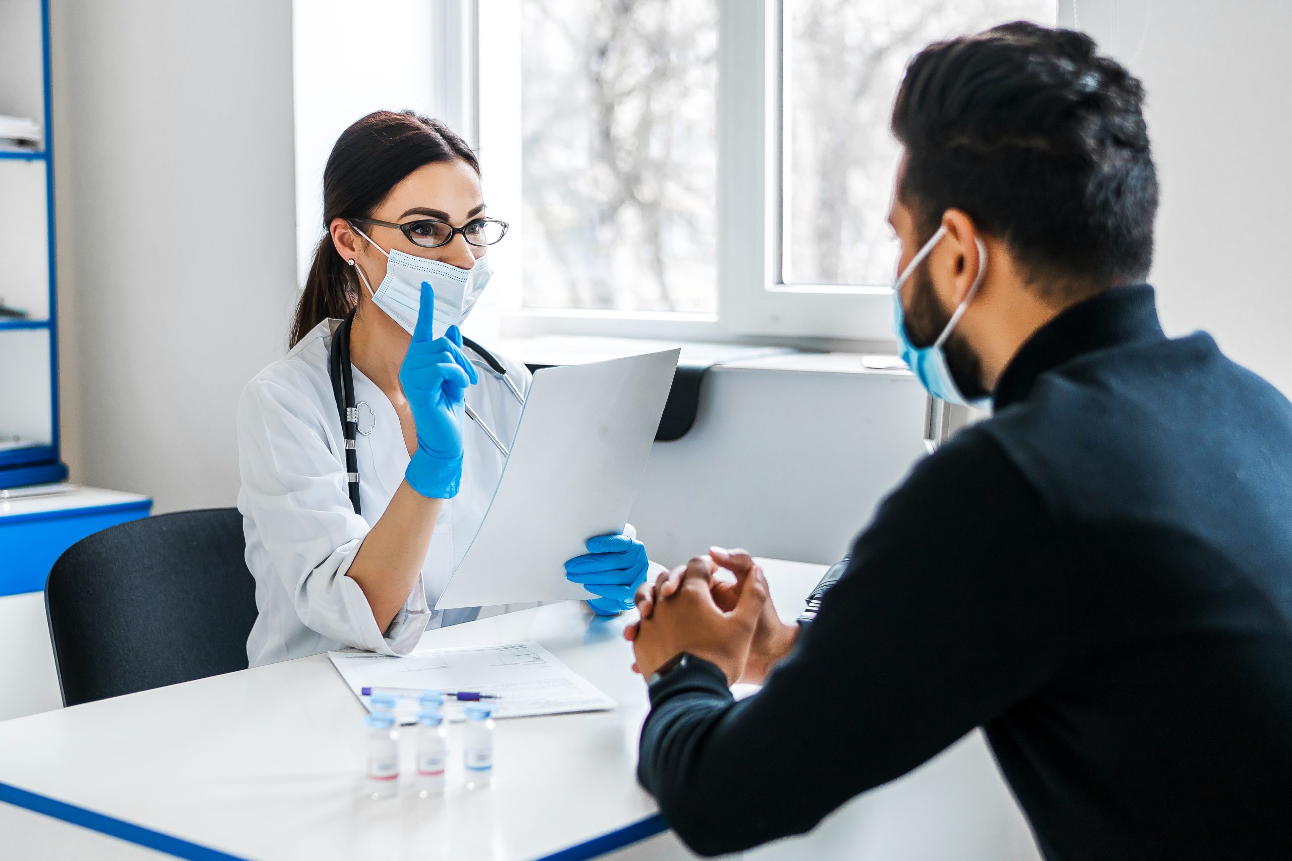female-doctor-consults-her-patient-holds-documents-her-hands-scaled.jpg