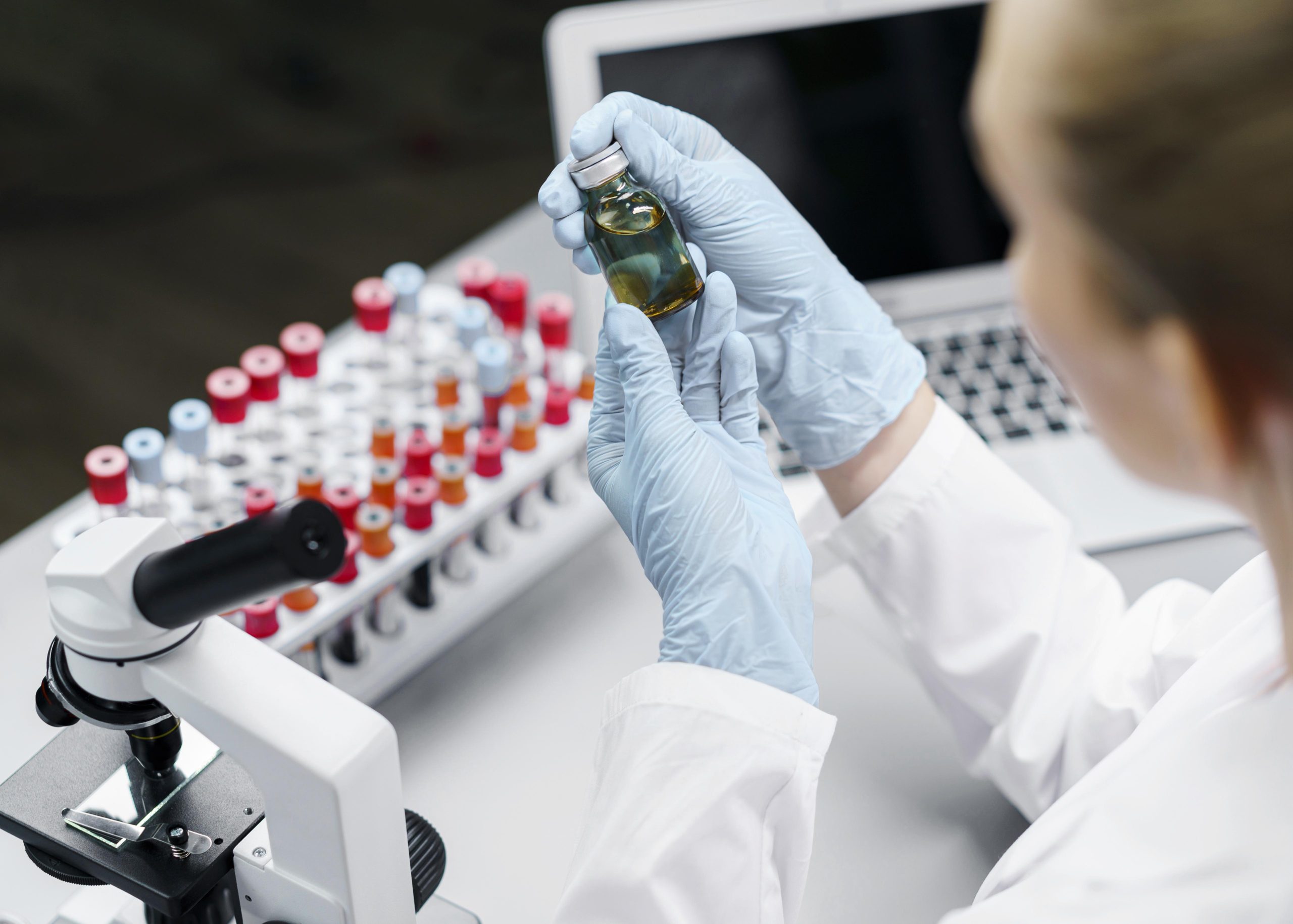 female-researcher-laboratory-with-test-tubes-vaccine-bottle-scaled.jpg