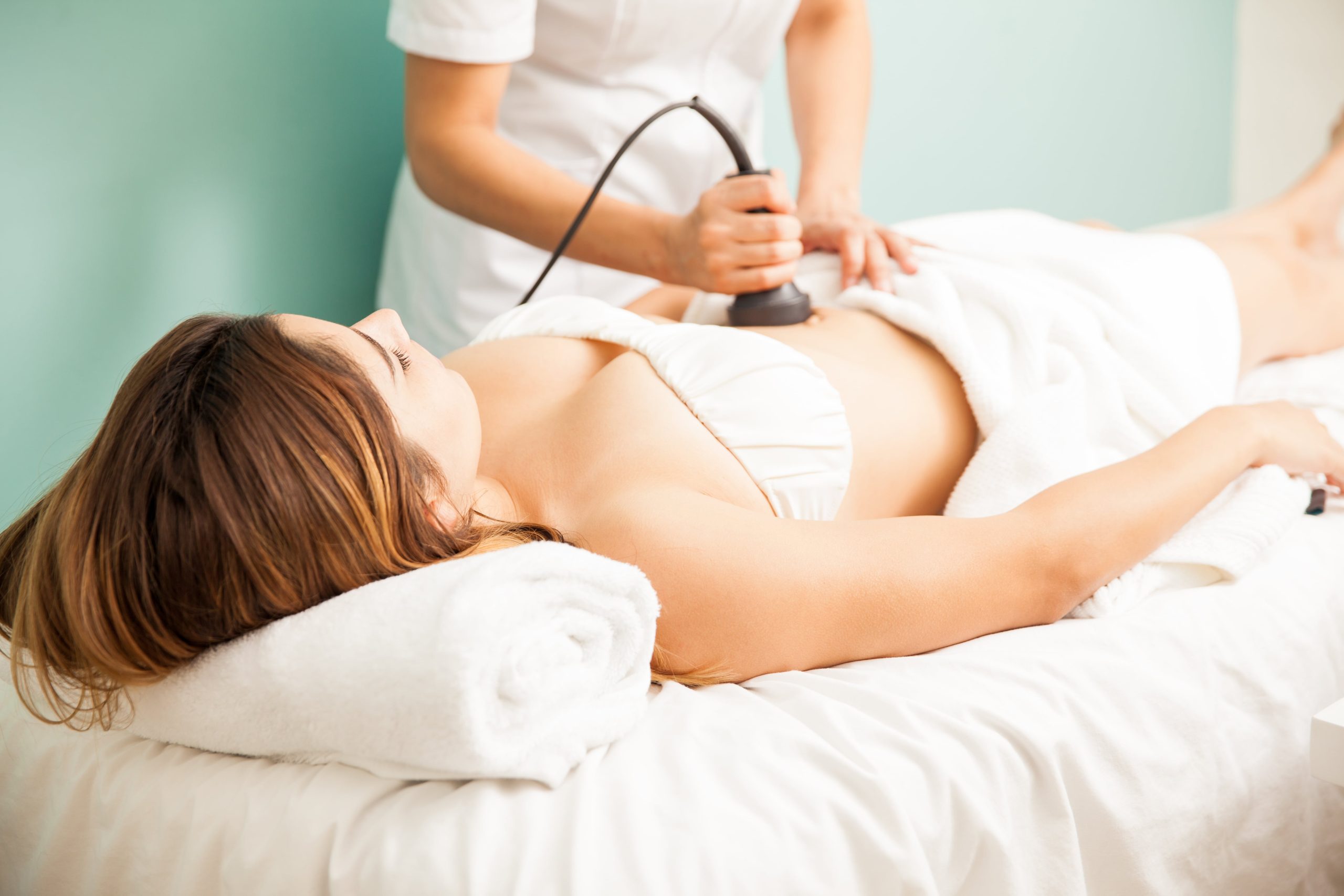 female-therapist-giving-reductive-reaffirming-treatment-client-focusing-her-belly-min-scaled.jpg
