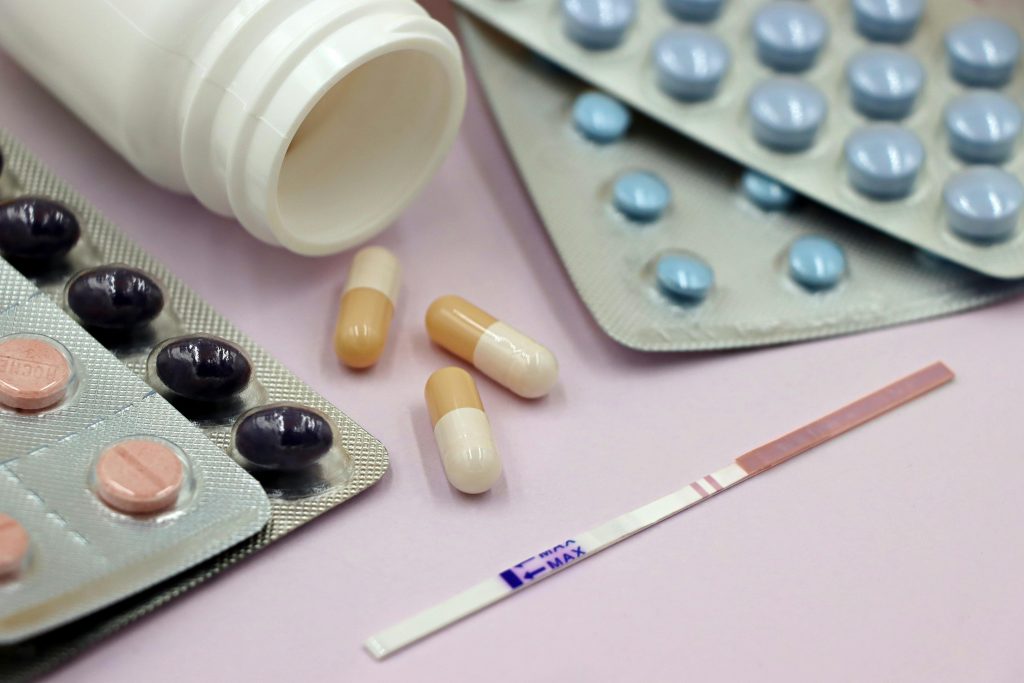 close-up, eye-level shot shows various medical items on a light surface