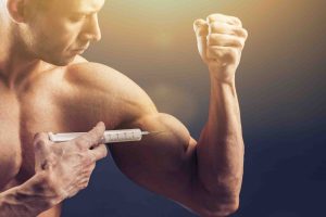Men injecting himself in his muscle
