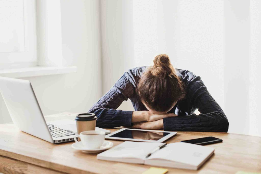 Women sobbing on her desk