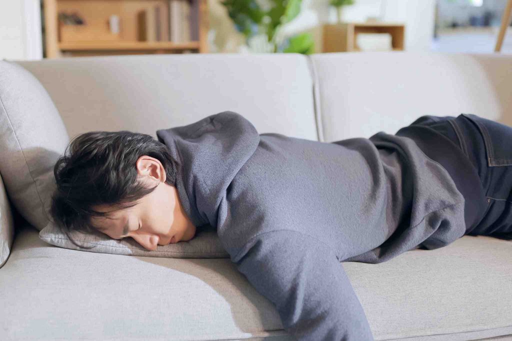 Men laying on his couch