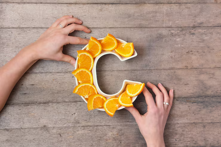 Woman's hands holding a white ceramic plate shaped like the letter 'C', filled with bright orange slices,