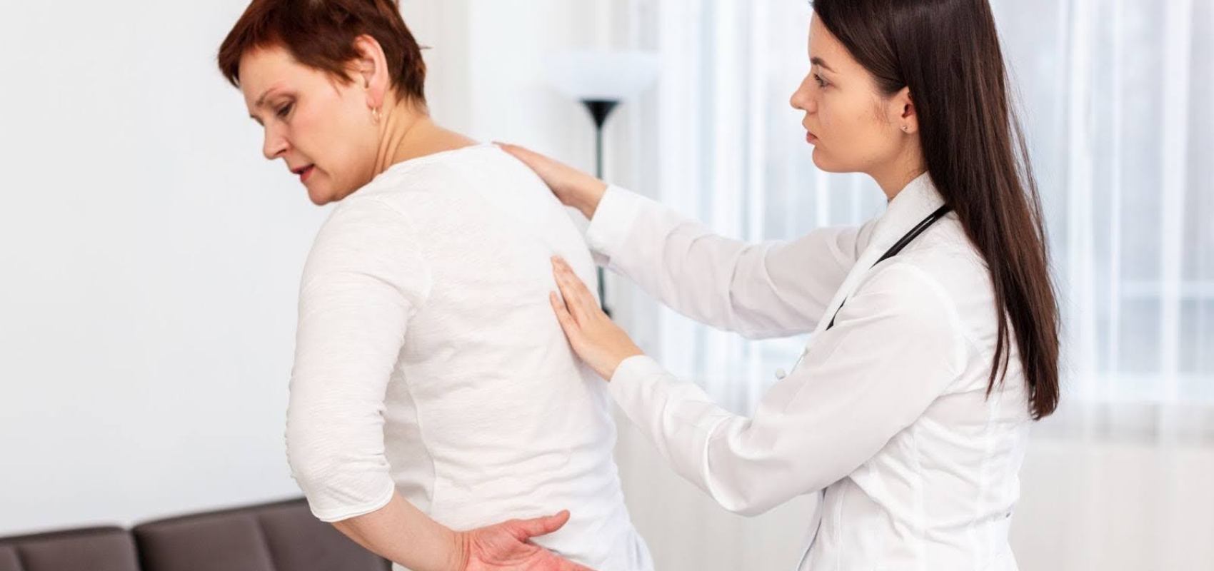 examining a woman's back