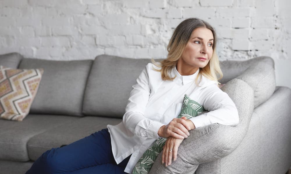 Woman on a sofa looking outside