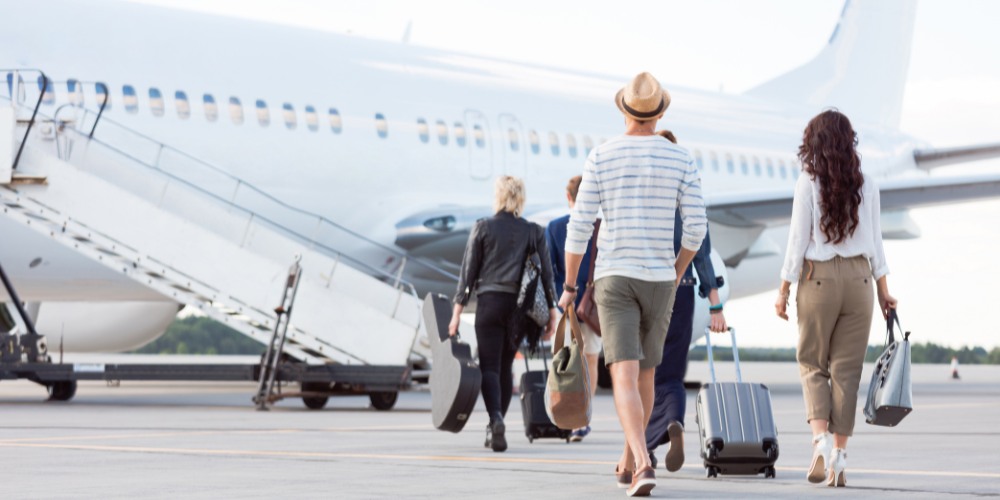 group of travelers carrying luggage