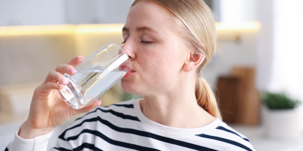 drinking a glass of water