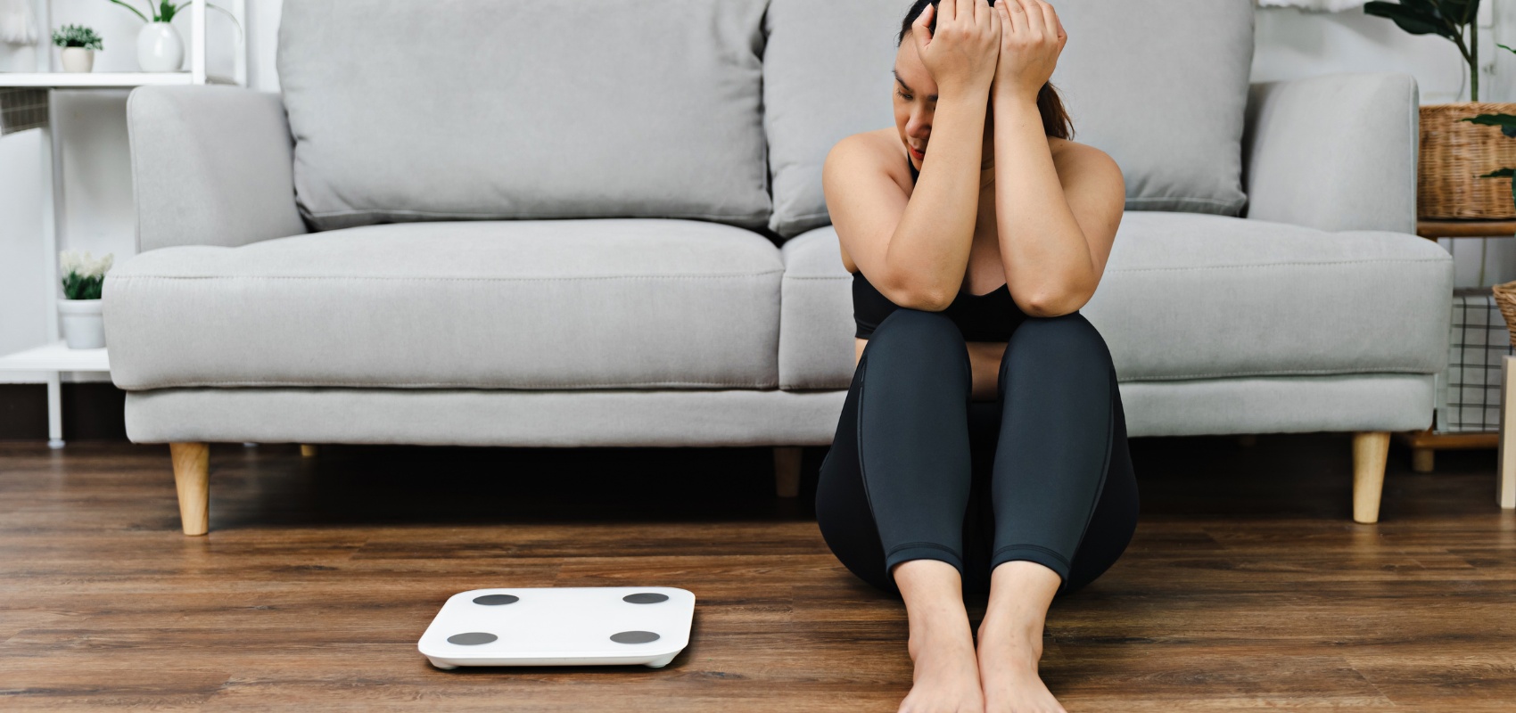 An upset woman sitting on the floor