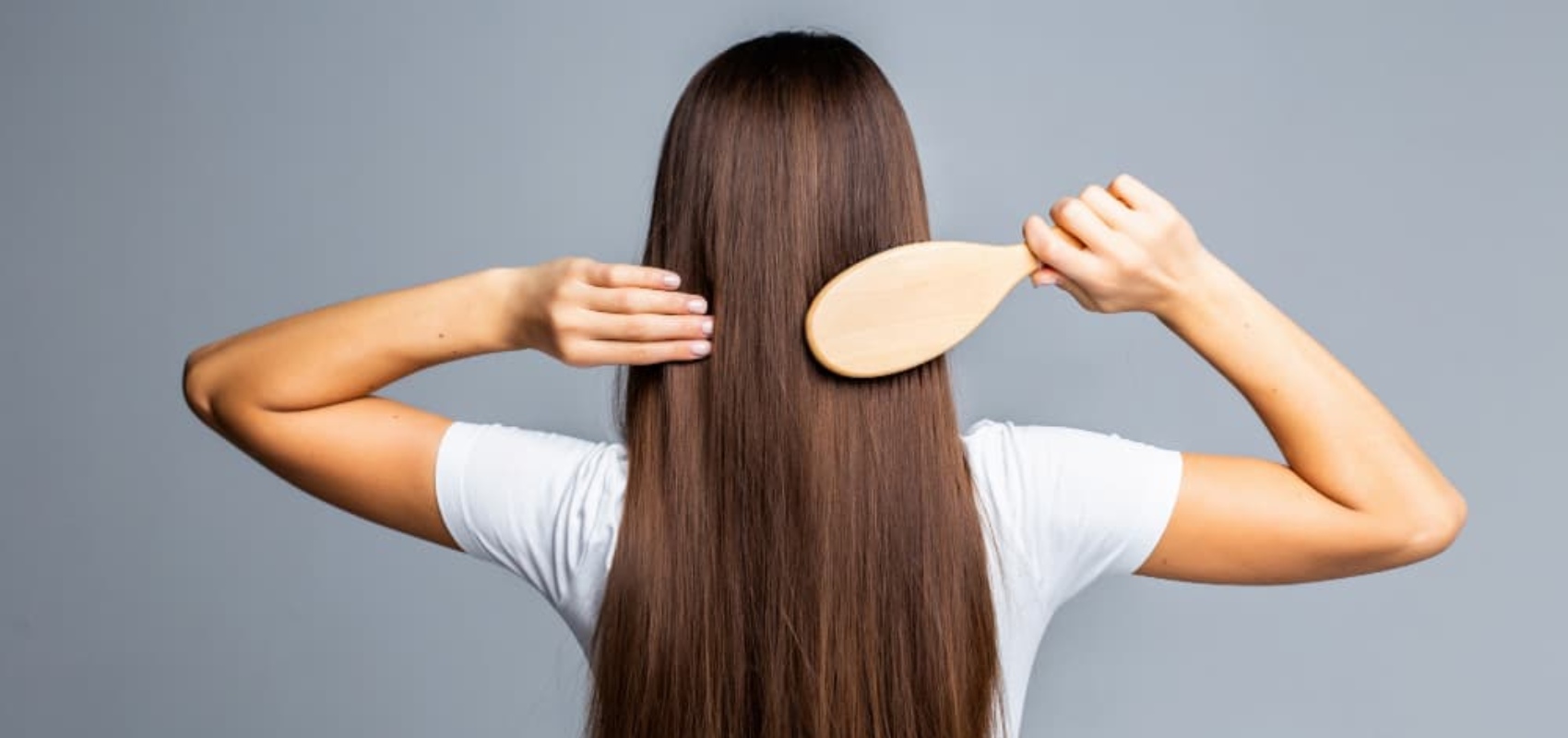 a girl on her back combing her hair