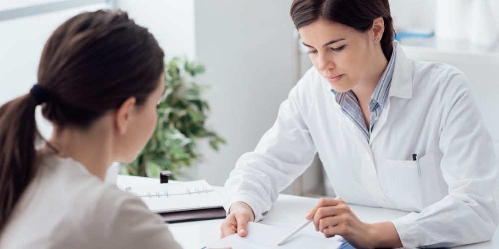 A female doctor in a white lab coat
