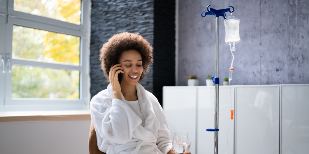 A smiling woman wearing a white bathrobe