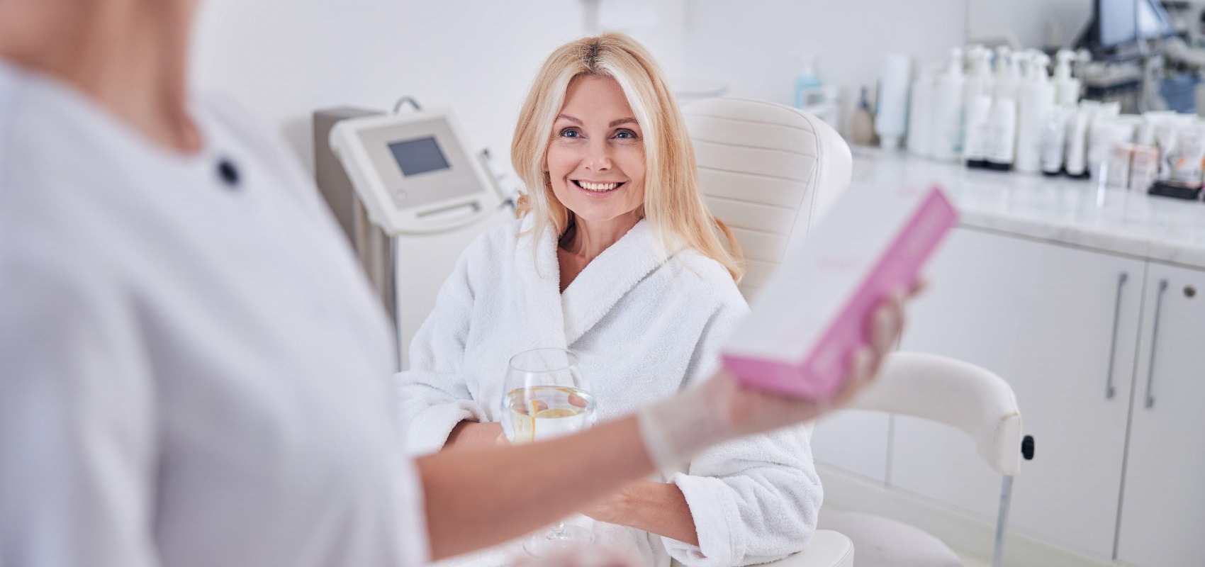 clinician shows a product box for an upcoming NAD+ treatment