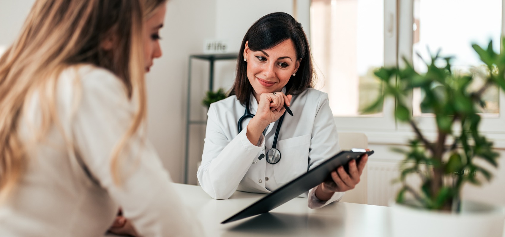 A female doctor reviews a medical chart