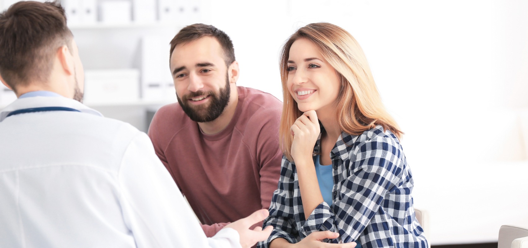 young couple listens attentively to a doctor