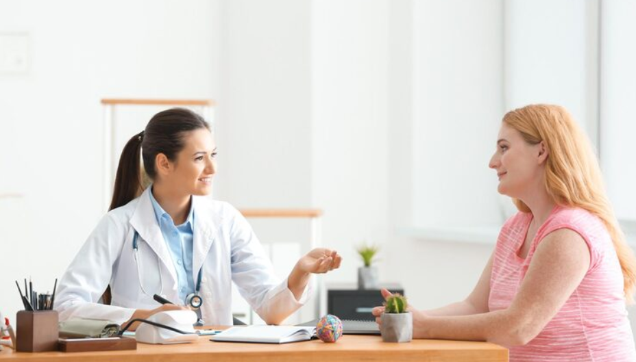 Young female doctor consulting a woman in clinic