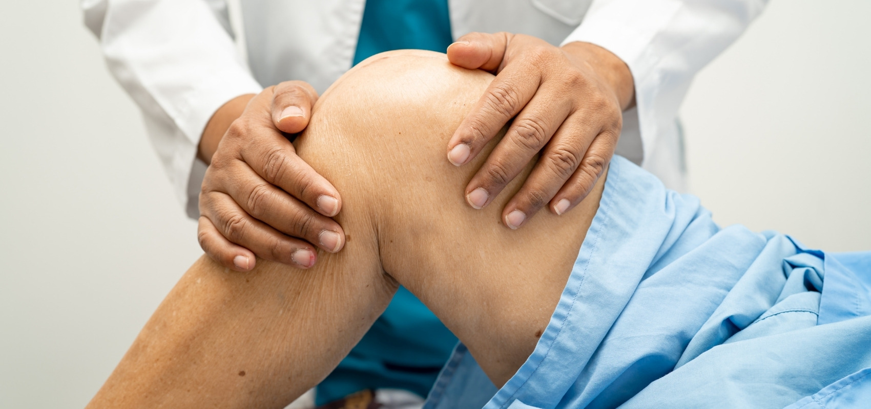 Doctor examining a patient's elevated knee