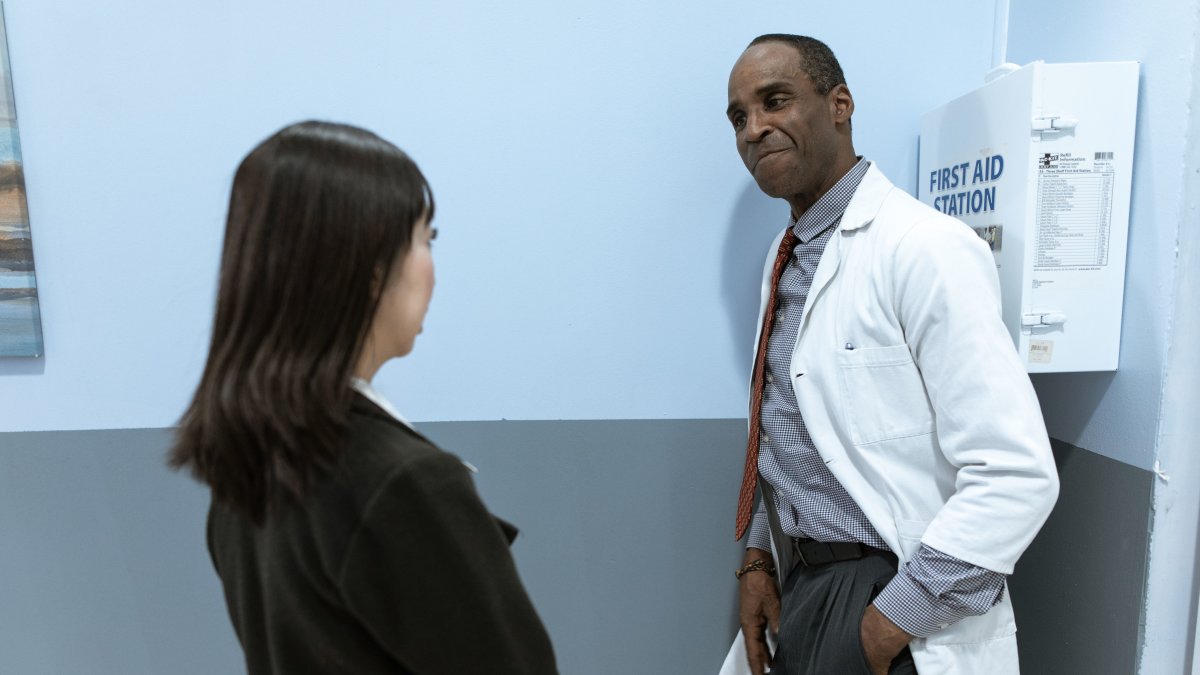 Medical professional conversing with patient in clinical setting